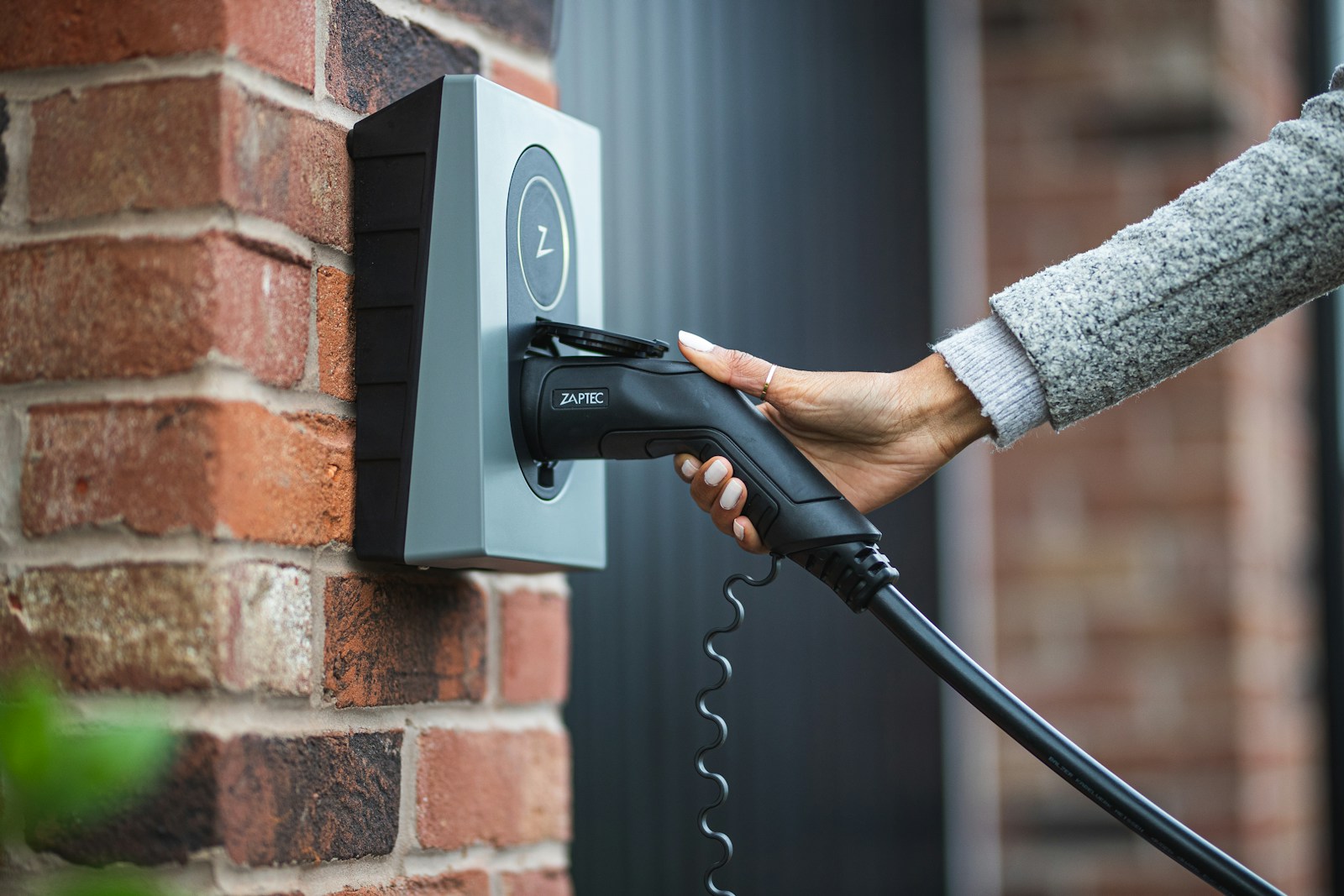 a person is charging an electric car with a charger